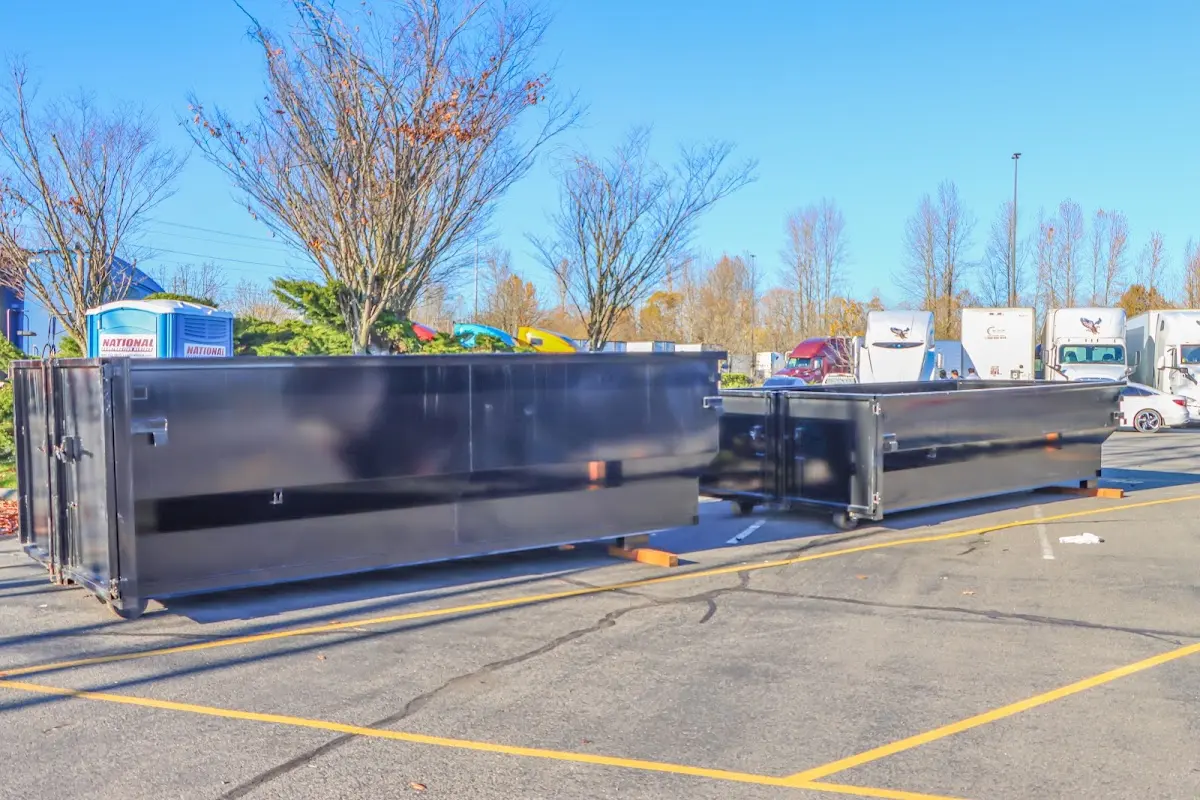 Professional dumpster rental service with roll-off container on residential driveway in Durham